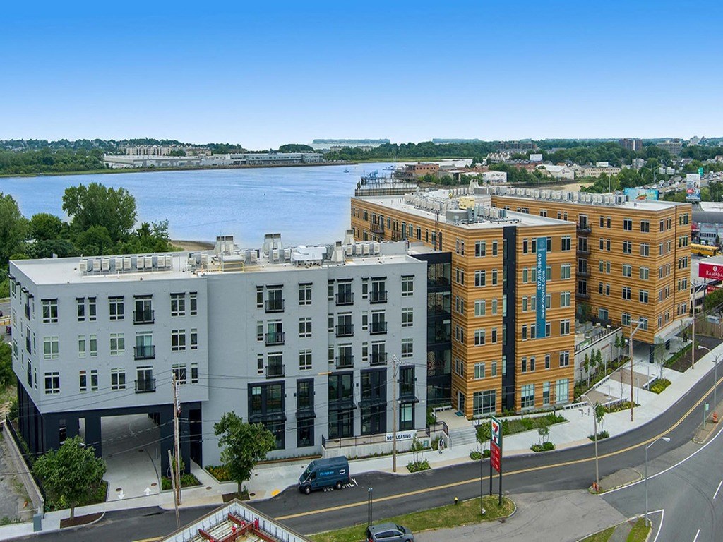 an aerial view of a building with a river in the background